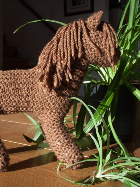 finished brown knit horse with a spider plant